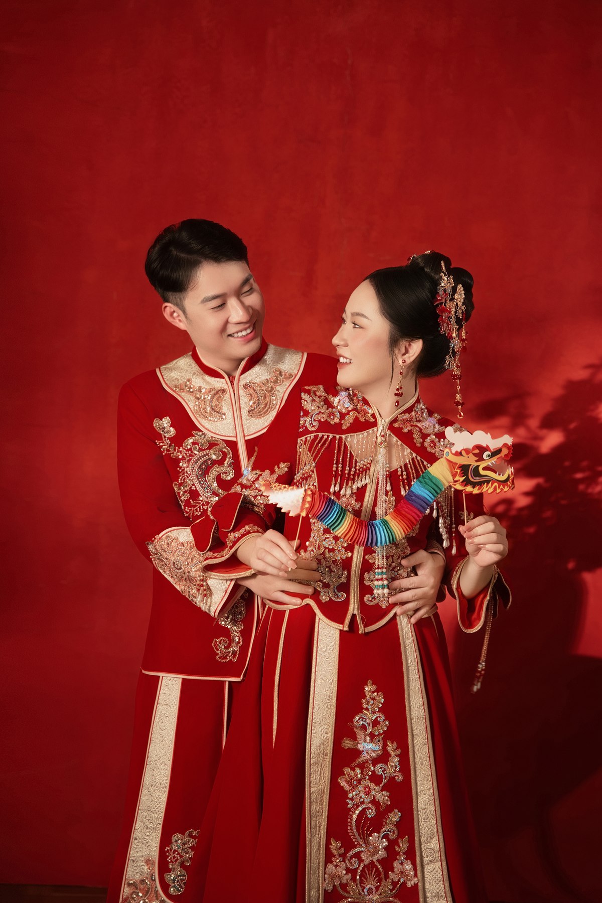 两位新人身穿中式礼服相视而笑
